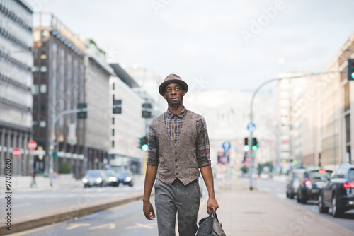 Knee figure of young handsome afro black man walking in the stre