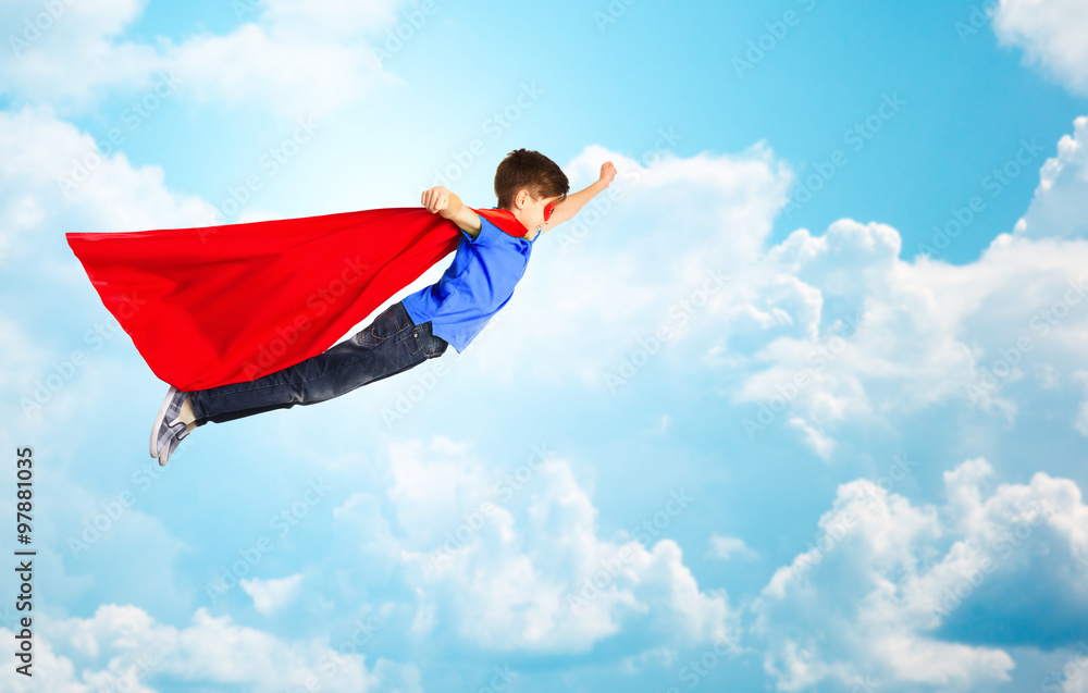 boy in red superhero cape and mask flying over sky boy in red superhero cape and mask flying over sky