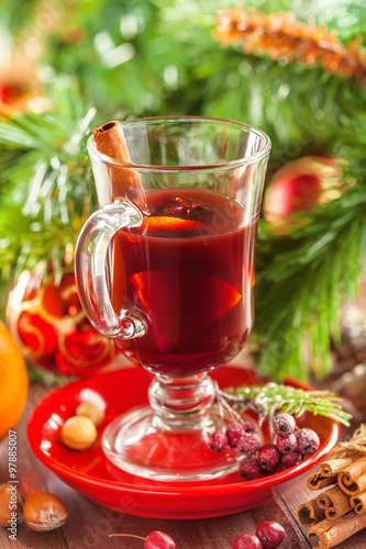 Christmas mulled wine in glass with citrus fruits and spices.