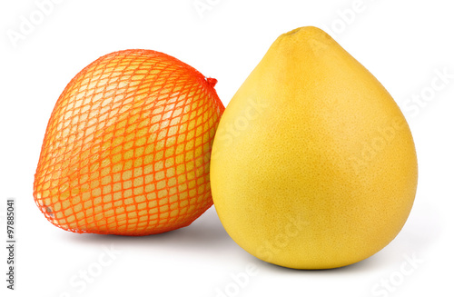 Two ripe pear-shaped pomelo fruit isolated on white background. One of them is wrapped in plastic mesh. photo