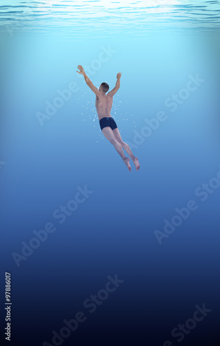 man swimming into deep blue water