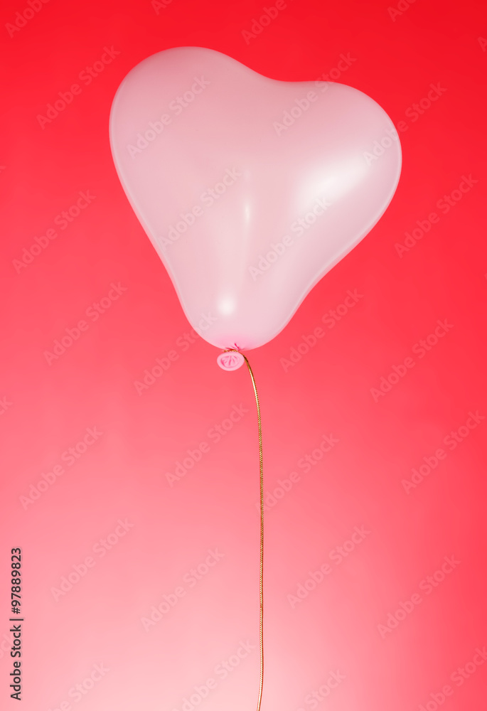 Balloon of heart form on red background