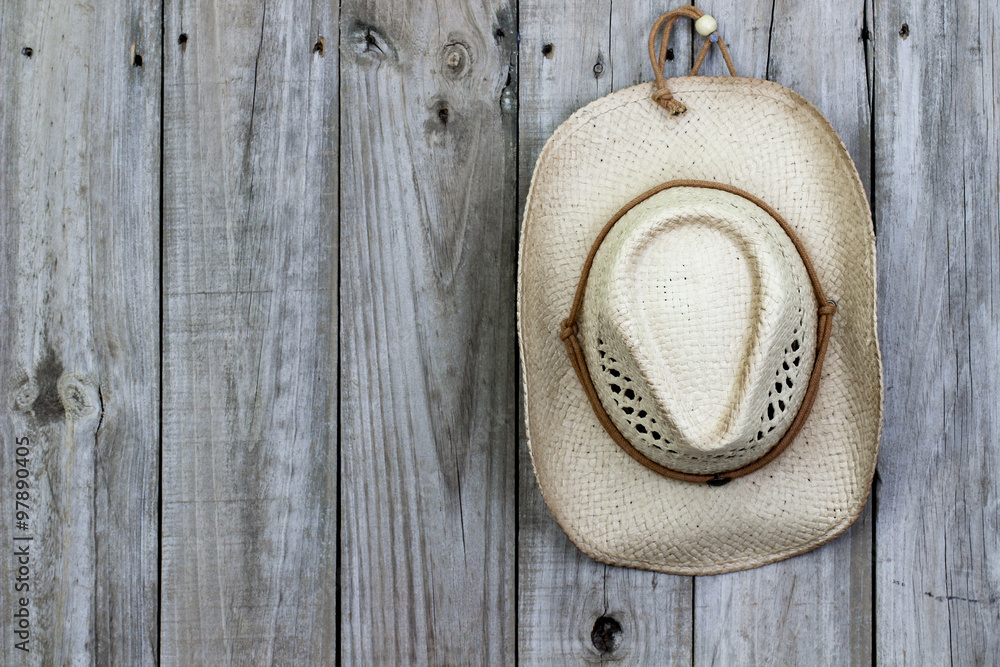 Cowboy hat hanging on rustic wood background Stock Photo | Adobe Stock