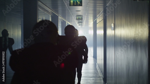  Team of American football players running through stadium tunnel photo