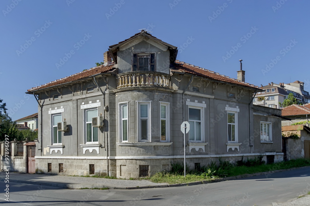 Fototapeta premium Razgrad town, street and house. Old corner house with balcony, Bulgaria 