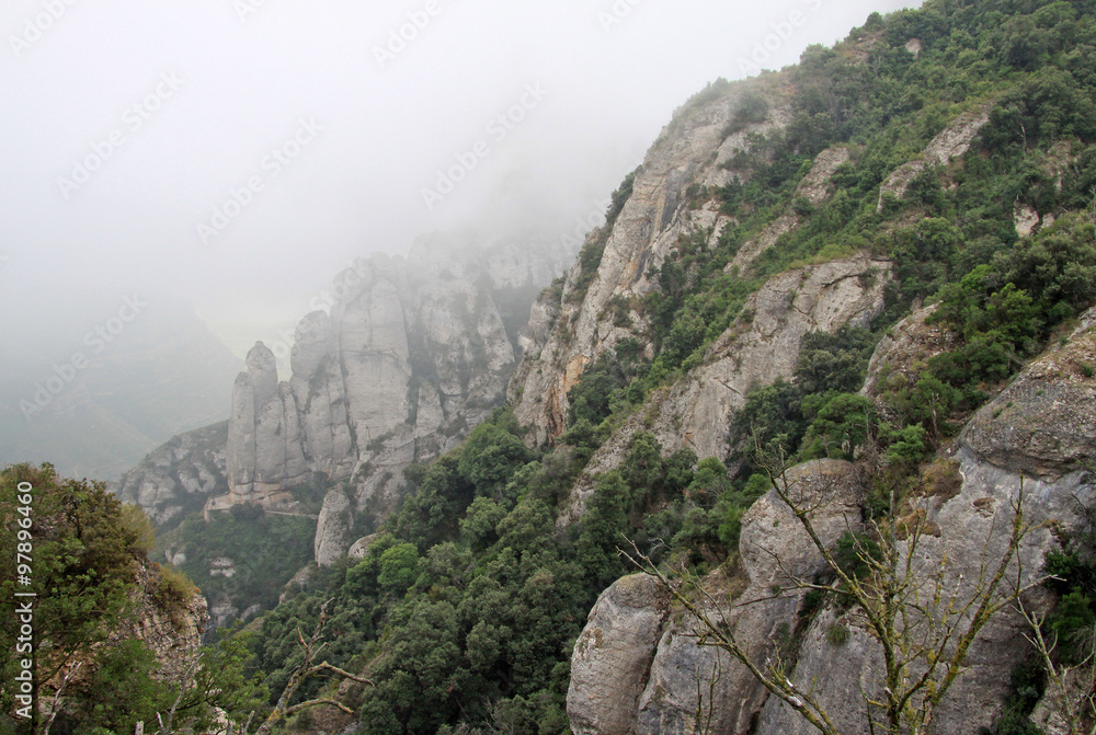 MONTSERRAT, SPAIN - AUGUST 28, 2012: Misty morning in the Montserrat mountains  at Benedictine abbey Santa Maria de Montserrat, Spain