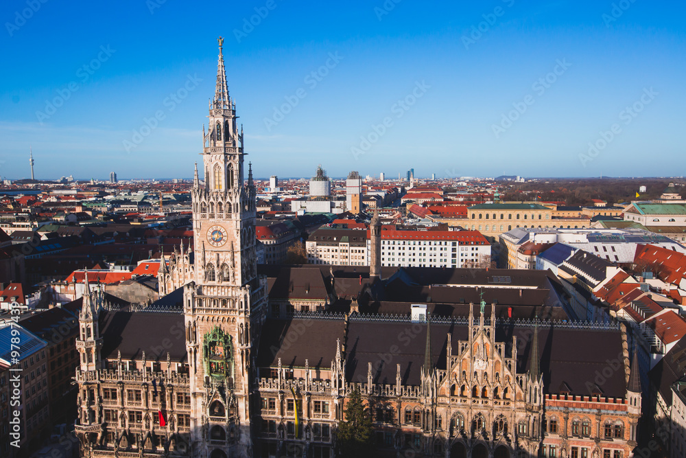 Beautiful super wide-angle sunny aerial view of Munich, Bayern, Bavaria, Germany with skyline and scenery beyond the city, seen from the observation deck of St. Peter Church 
