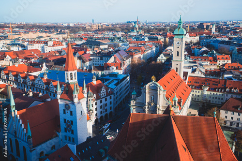 Beautiful super wide-angle sunny aerial view of Munich, Bayern, Bavaria, Germany with skyline and scenery beyond the city, seen from the observation deck of St. Peter Church 