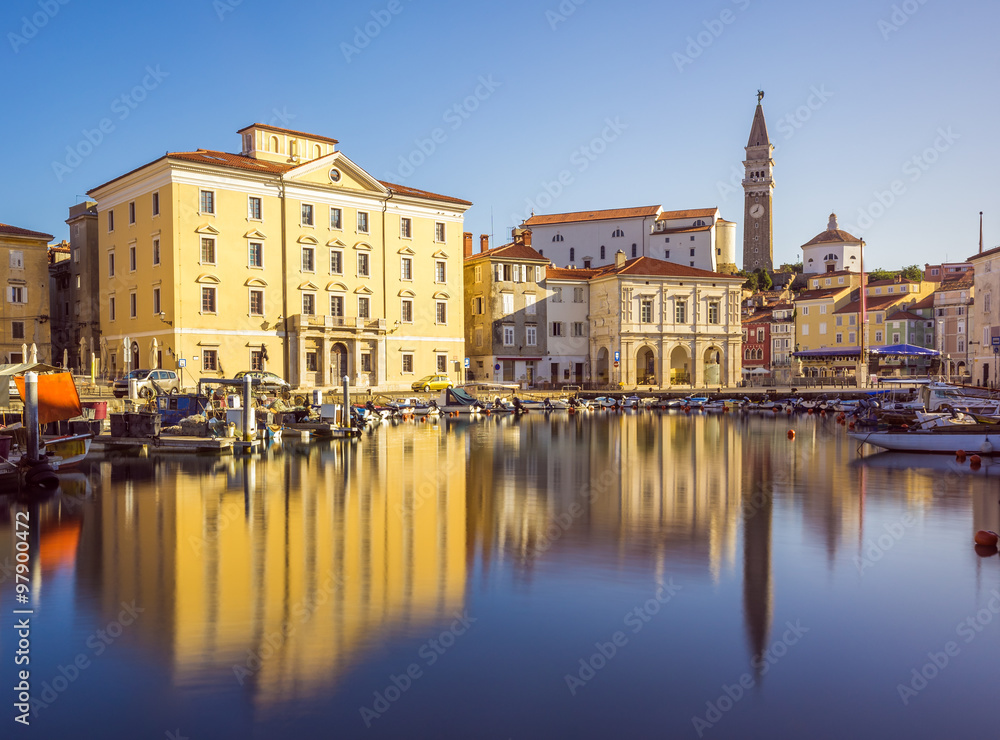 Buildings on the Main Square Tartini of Piran City Reflected on Water in Slovenia.