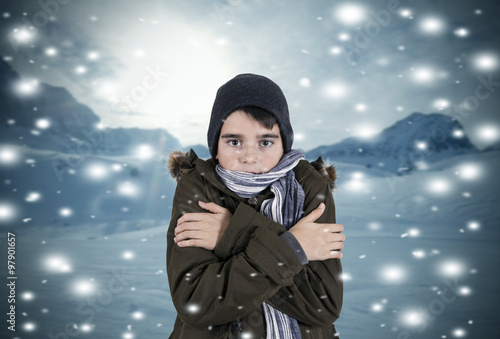 child with clothes in snowy landscape