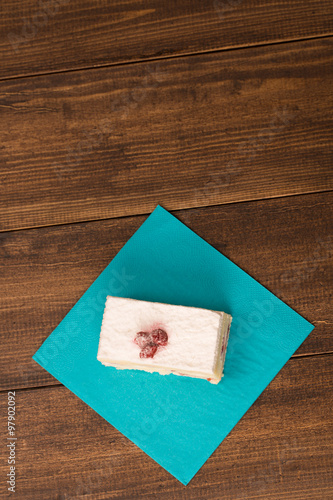 cake with fresh cherry on wooden background