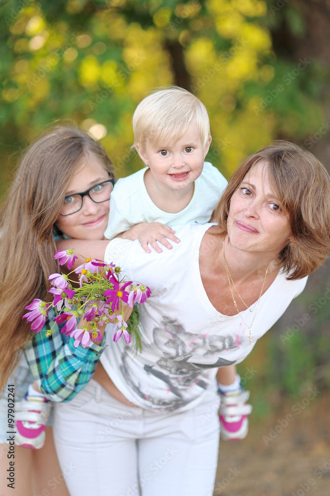 portrait of a happy family in the summer on the nature portrait of a happy family in the summer on the nature
