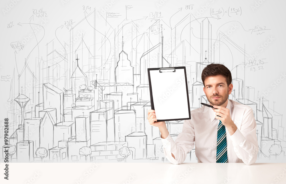 Businessman sitting at the white table with hand drawn buildings