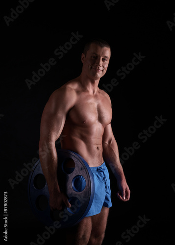 Bodybuilding. Studio photo of smiling athlete © Wisky