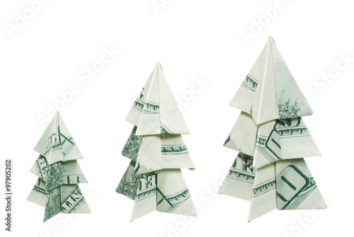 Christmas trees made of hundred dollar bills on a white background