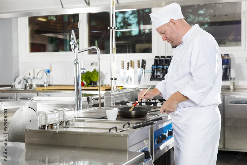 Chef using brush to prepare a dish in the kitchen Chef using brush to prepare a dish in the kitchen