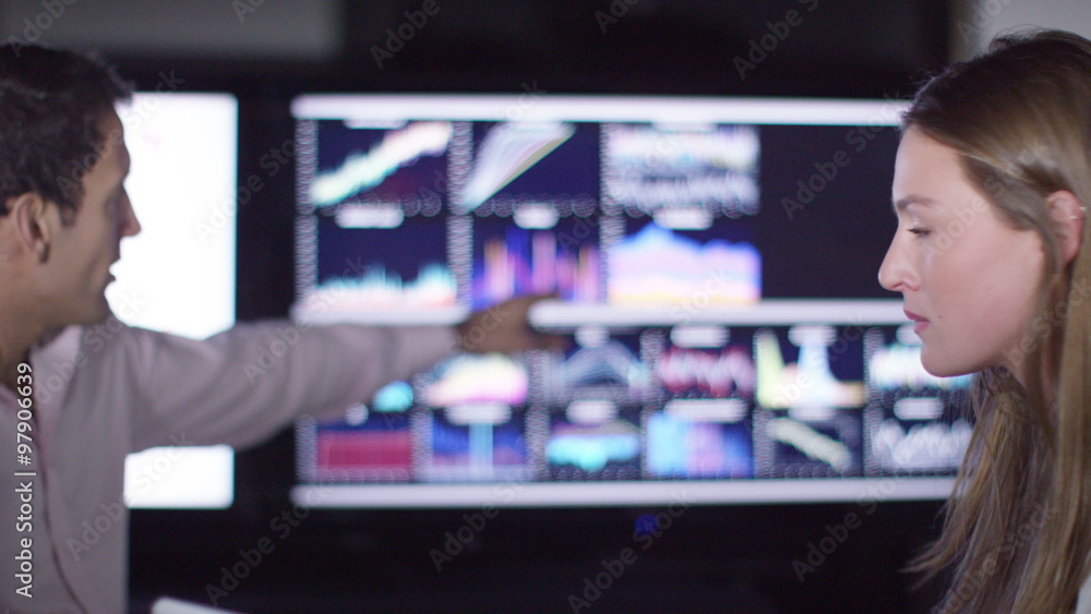 Business group in a meeting looking over the company figures . Shot on RED Epic. Business group in a meeting looking over the company figures . Shot on RED Epic.