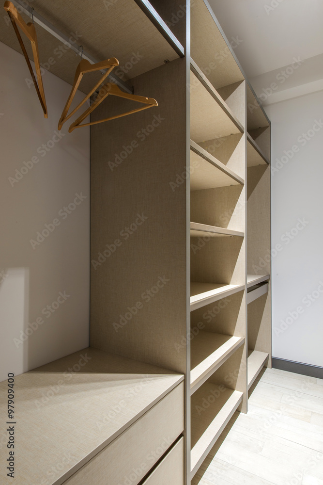 Big wooden wardrobe interior in modern home Big wooden wardrobe interior in modern home