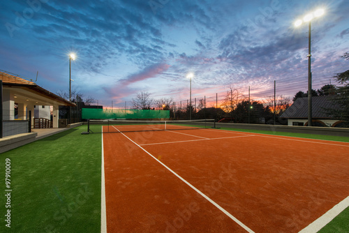 Tennis court at a private estate in the twilight and magic sky © poplasen