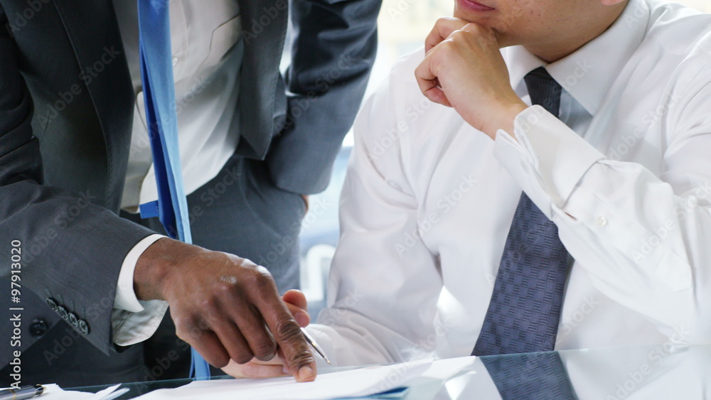 Business manager discussing figures with a work colleague Business manager discussing figures with a work colleague