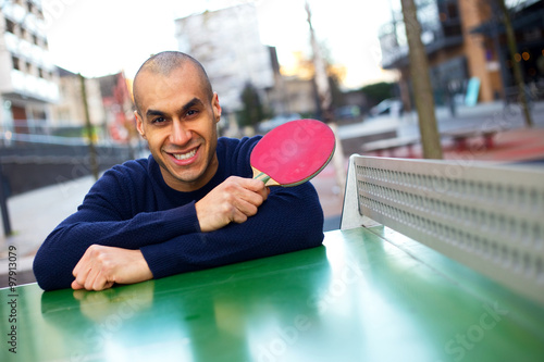 table tennis player posing holding a racket