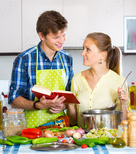 Young husband helping wife