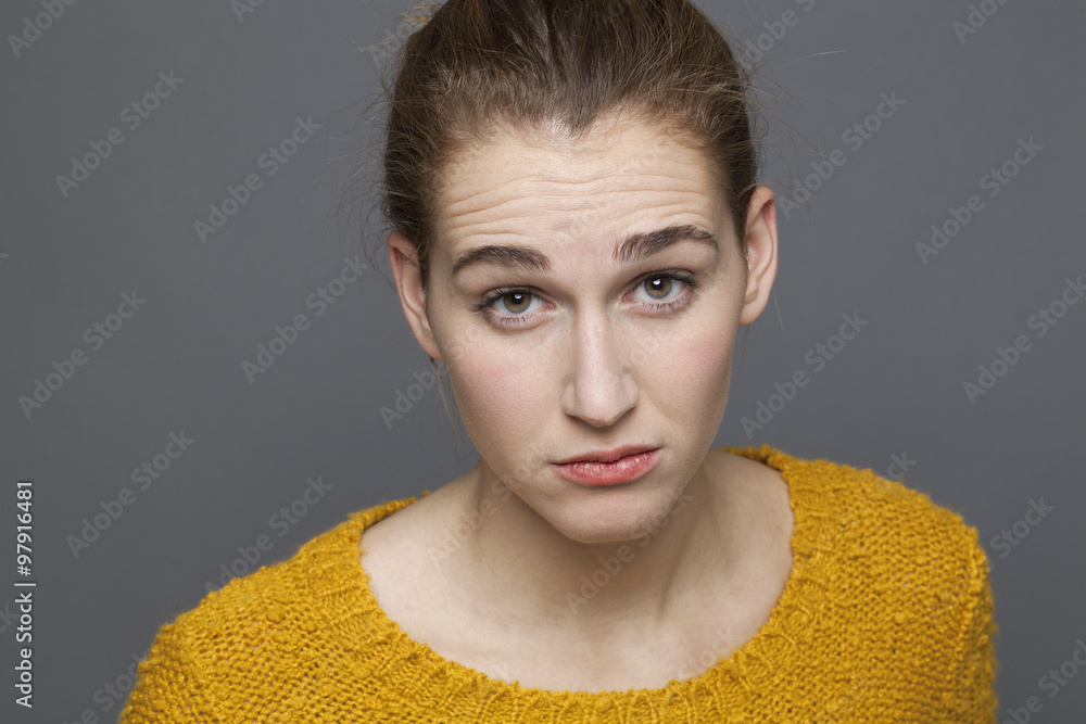 doubt and confusion concept - portrait of skeptical beautiful 20s girl looking with arrogance for distrust,studio shot on gray background doubt and confusion concept - portrait of skeptical beautiful 20s girl looking with arrogance for distrust,studio shot on gray background