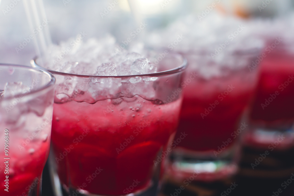 Beautiful row line of different colored alcohol cocktails with mint on a christmas party, martini, vodka with bubbles, wine and others on decorated catering bouquet table on open air event, picture Beautiful row line of different colored alcohol cocktails with mint on a christmas party, martini, vodka with bubbles, wine and others on decorated catering bouquet table on open air event, picture
