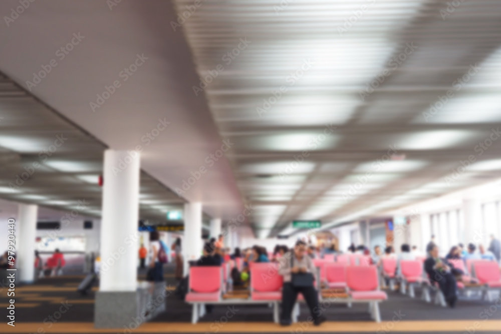 Defocus blurred picture of travellers, passengers waiting for their flight at airport Defocus blurred picture of travellers, passengers waiting for their flight at airport