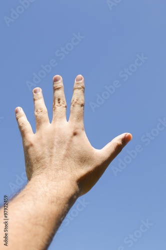 Man hand on blue sky