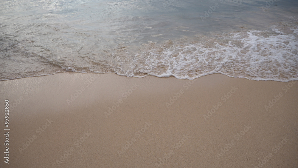 Soft white wave of the sea on the sandy beach at Phuket, Thailand. Copy space for some text. Soft white wave of the sea on the sandy beach at Phuket, Thailand. Copy space for some text.