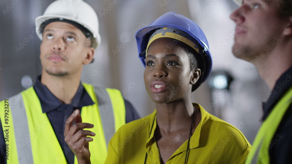 Confident female engineer or architect discussing construction issues with male colleagues. Confident female engineer or architect discussing construction issues with male colleagues.