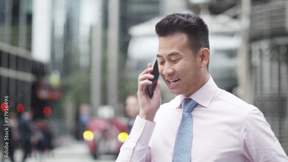 Portrait of 2 cheerful Asian businessmen chatting outdoors in the city Portrait of 2 cheerful Asian businessmen chatting outdoors in the city