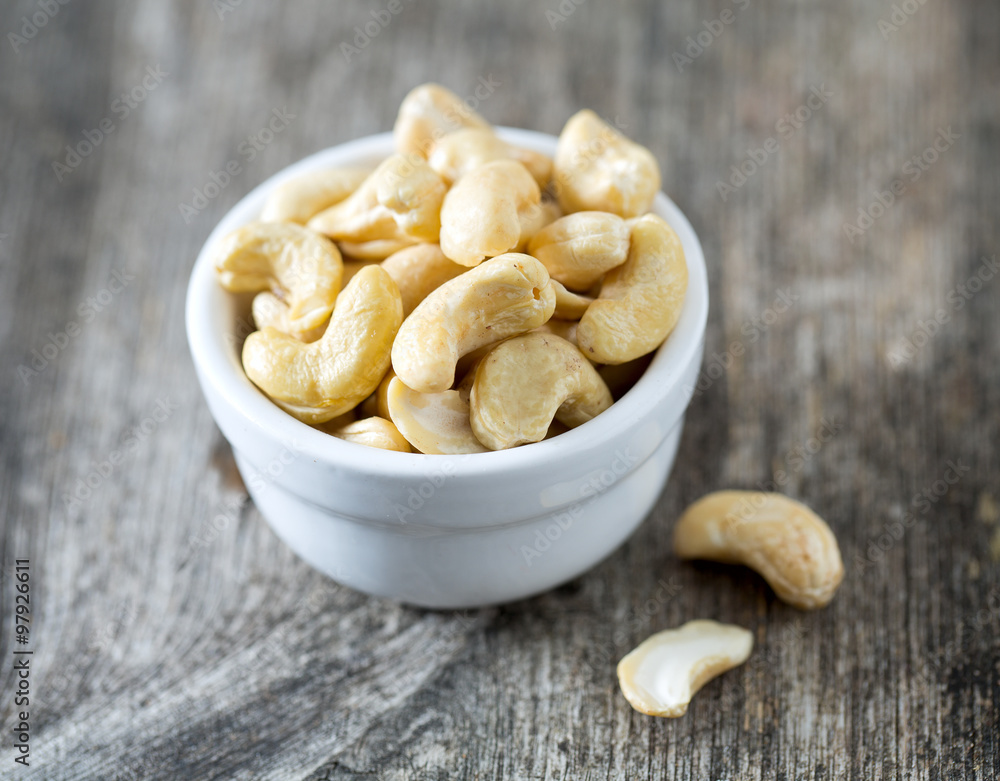 cashew nuts on wooden surface cashew nuts on wooden surface