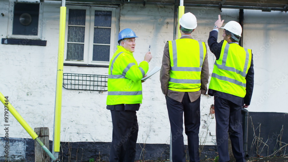 Engineers or architects conducting an inspection on construction site Engineers or architects conducting an inspection on construction site