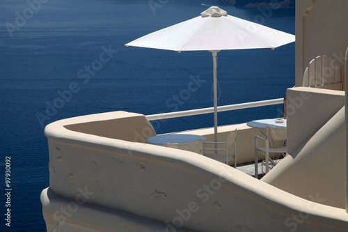 White umbrella on balcony resort house and Aegean sea, Santorini © Inna Felker