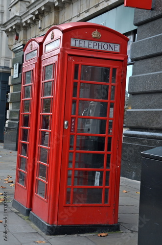 traditional British red phone boxes in London city centre street.