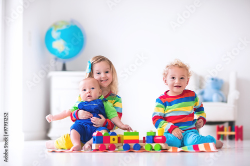 Kids playing with wooden toy train