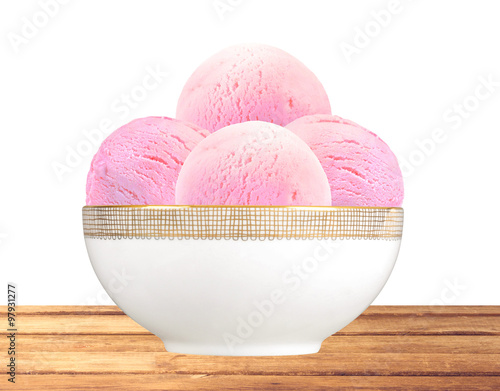 Scoop of fruit ice cream in plate on wooden table isolated on wh