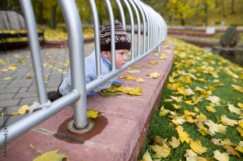 a boy of two years on a walk in a city park