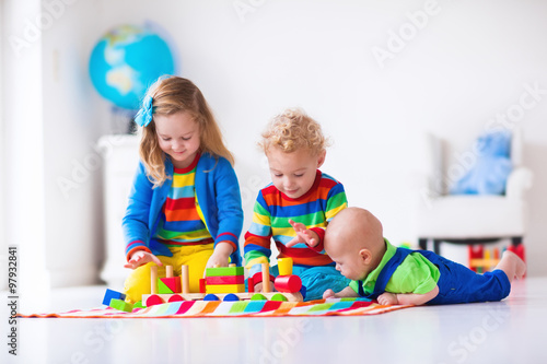 Kids playing with wooden toy train