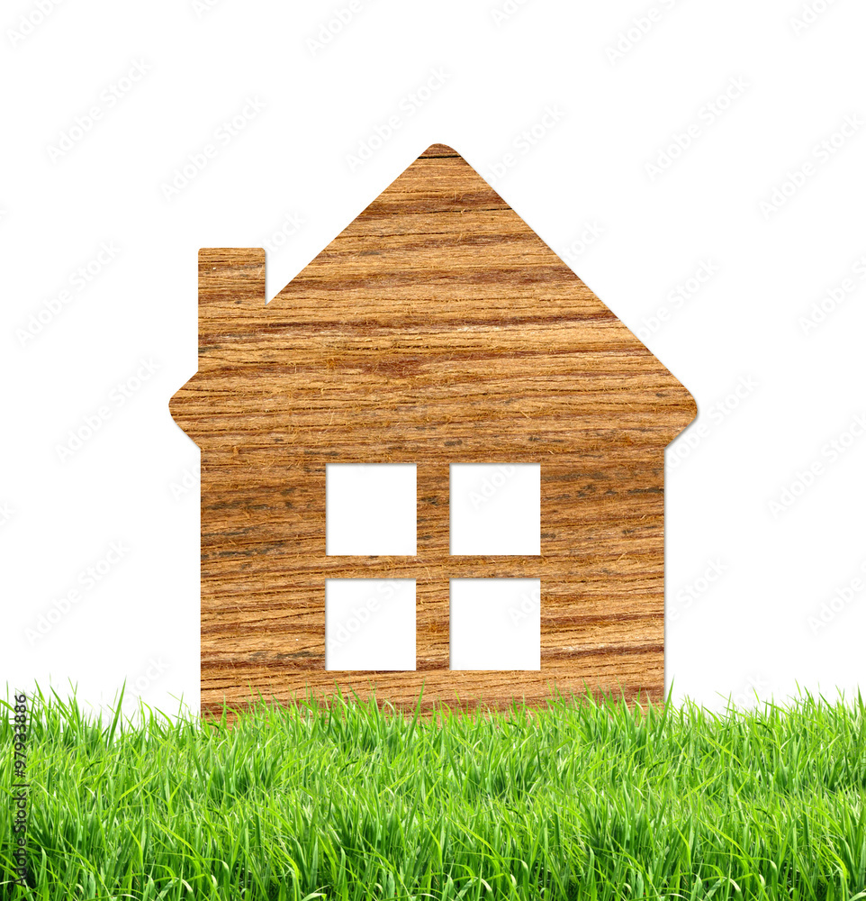Wooden home icon on green grass, isolated on white Wooden home icon on green grass, isolated on white
