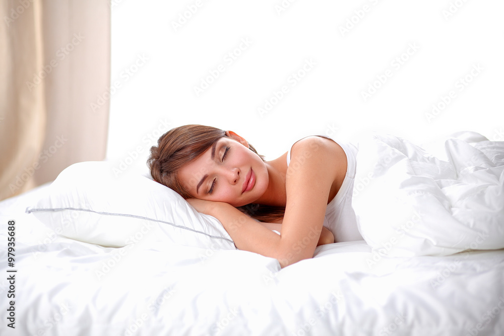 Beautiful girl sleeps in the bedroom, lying on bed Beautiful girl sleeps in the bedroom, lying on bed