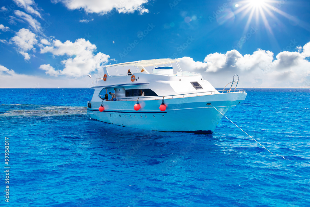 White yacht in the blue tropical sea White yacht in the blue tropical sea