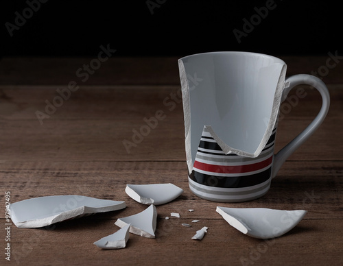 broken cup on wooden background