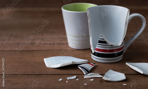 broken cup on wooden background