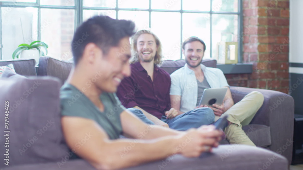 Young friends relaxing together at home with technology Young friends relaxing together at home with technology