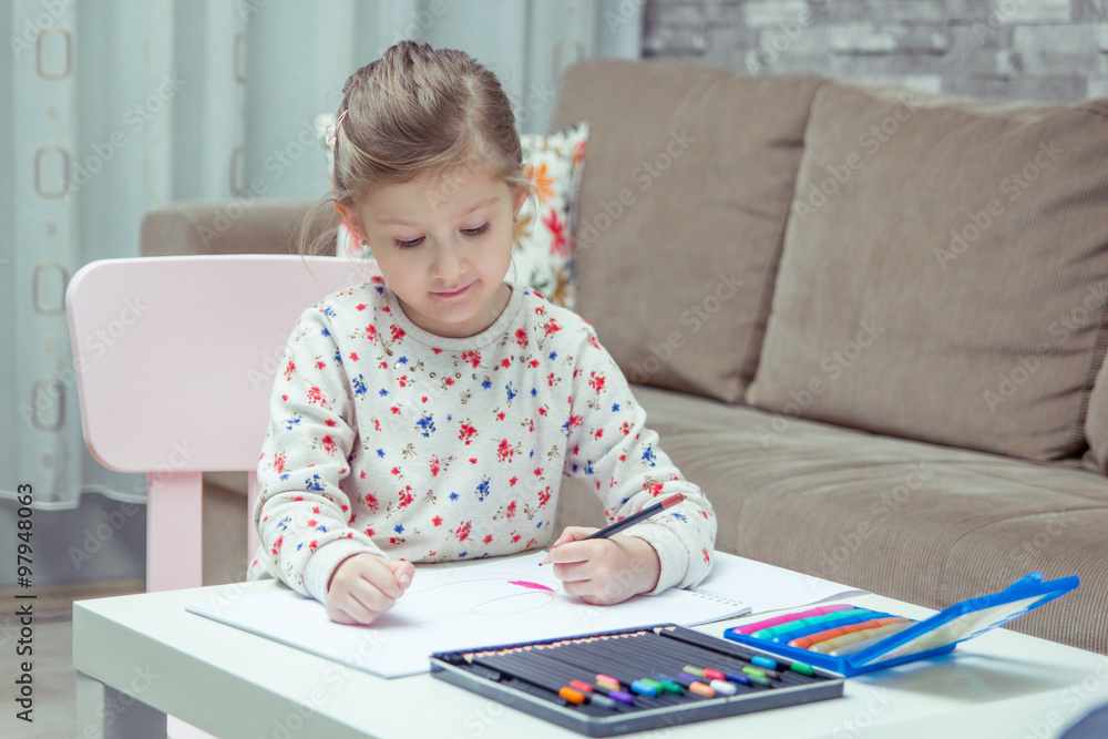Little girl is painting and drawing with pencil. Little girl is painting and drawing with pencil.