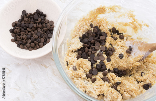 Adding chocolate chips to cookie dough