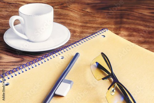 pencil and notebook, cup of coffee, glasses, Eraser, on a wooden